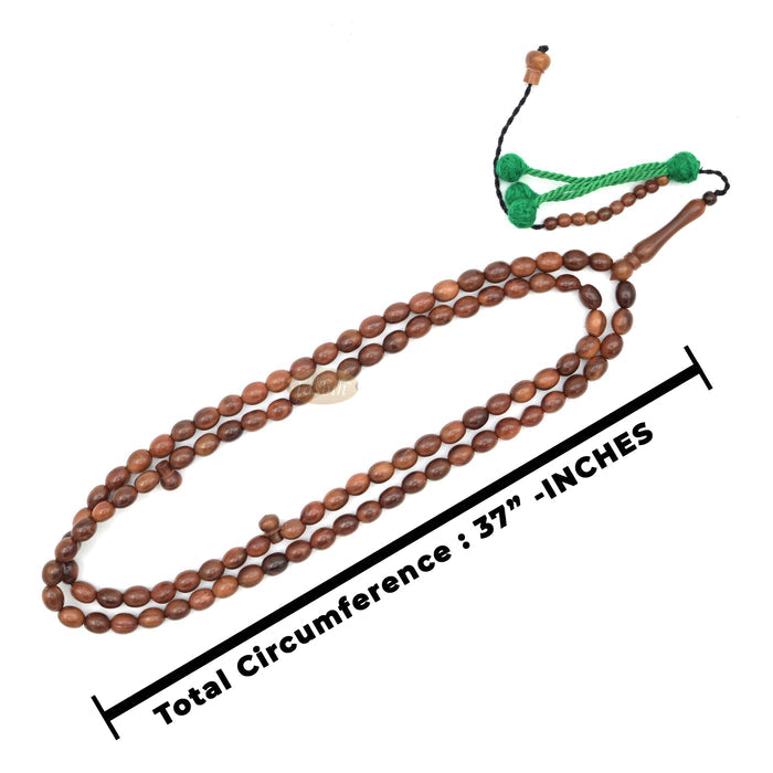 Brown wooden Islamic misbaha prayer beads with elongated oval beads and green tassels.