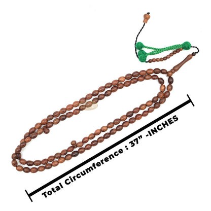 Brown wooden Islamic misbaha prayer beads with elongated oval beads and green tassels.